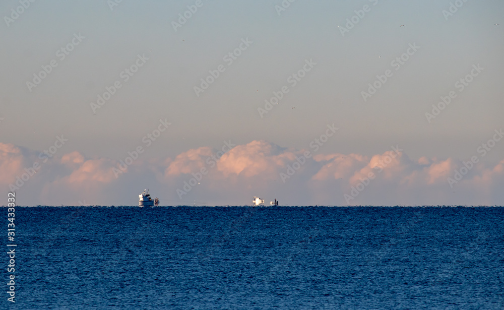 Multiple blurred ships in the distance, dissapearing in the horizon from earth curvature