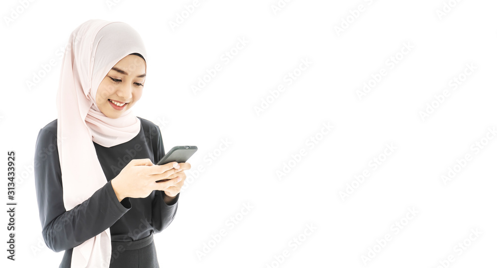 Portrait of beautiful asian muslim woman in a black hijab smiling and using mobile phone isolated over white background Portrait of beautiful asian muslim woman in a black hijab smiling and using mobile phone isolated over white background