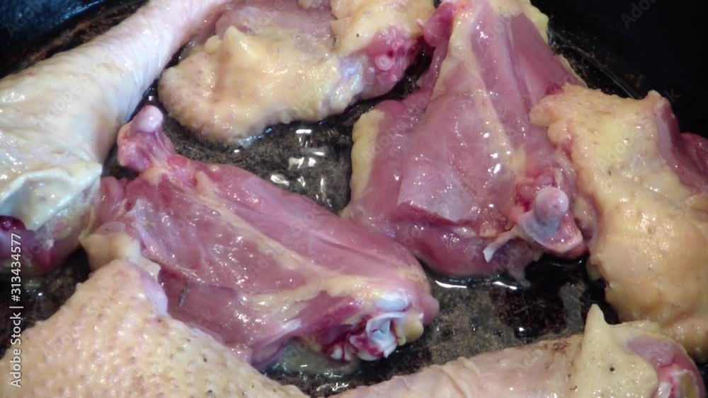 Fry chicken meat in a pan . Chicken thighs in a frying pan Fry chicken meat in a pan . Chicken thighs in a frying pan