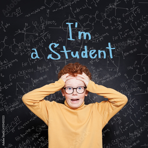 Little boy touching his hands his head against science background