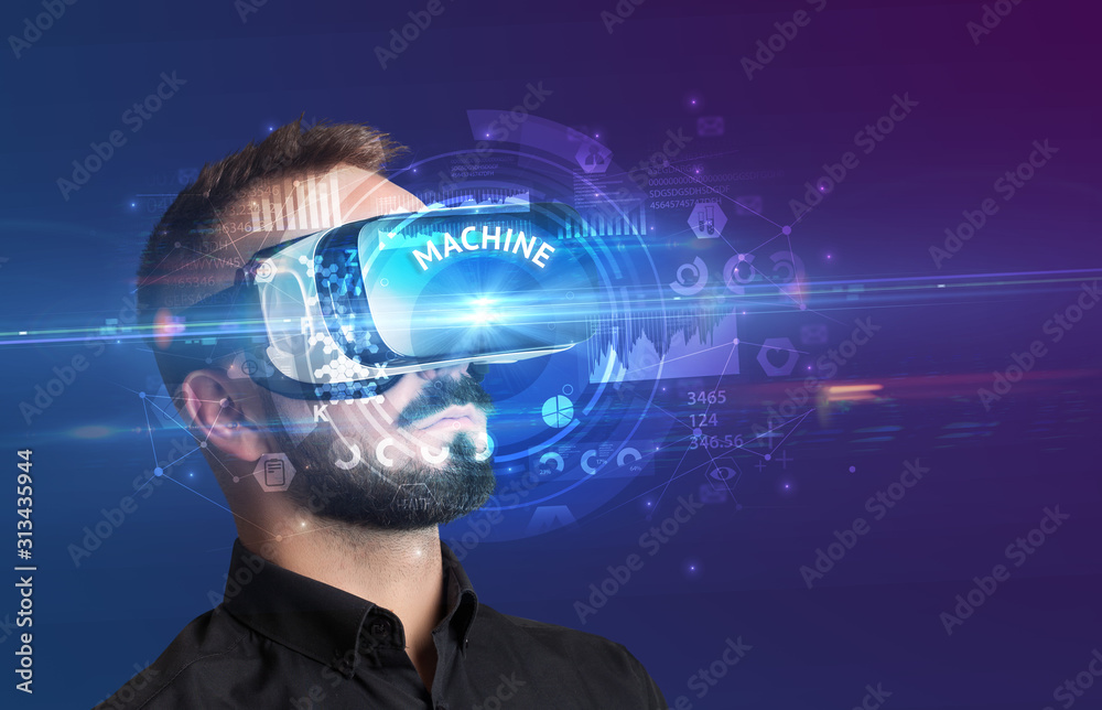 Businessman looking through Virtual Reality glasses with MACHINE inscription, innovative technology concept