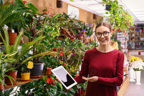 Female business owner with tablet in flower shop
