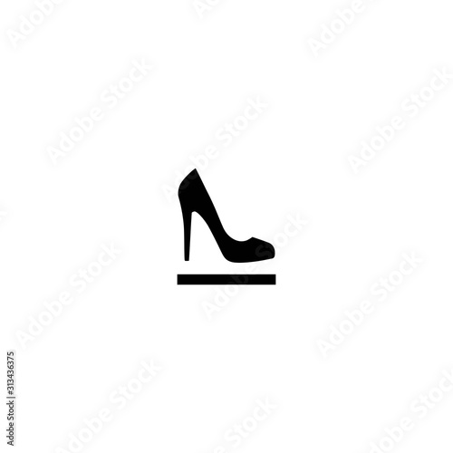 Female shoe with high heel on pedestal. Elegant black slipper with spike heel on while background.