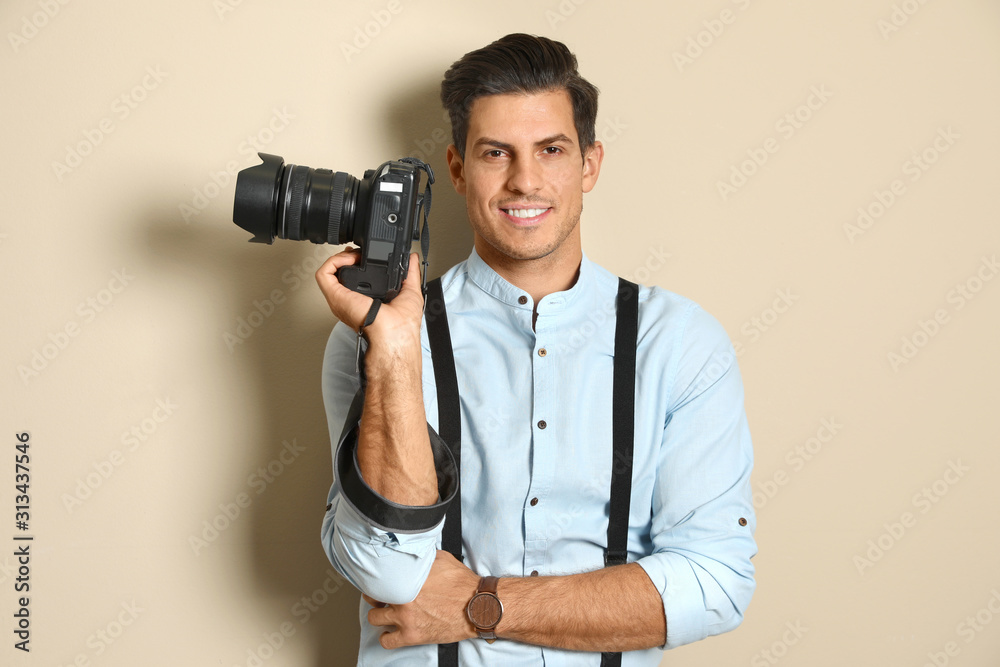 Fototapeta premium Professional photographer working on beige background in studio