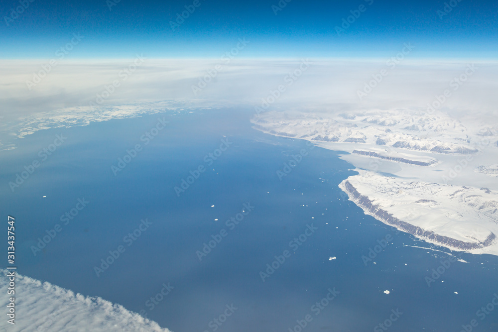 Fototapeta premium An aerial view of a frozen Greenland landscape, taken from an airplane