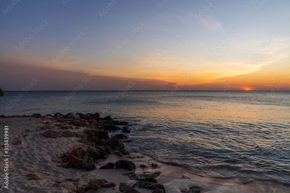Gorgeous colorful sunset on Caribbean sea, Unforgettable view of Aruba landscape. Beautiful nature background.