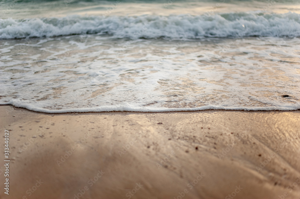 Sea, beach, sand, wave, summer, background concept. White waves on a sandy beach in the summer on sunset. Background sea concept. Sea, beach, sand, wave, summer, background concept. White waves on a sandy beach in the summer on sunset. Background sea concept.