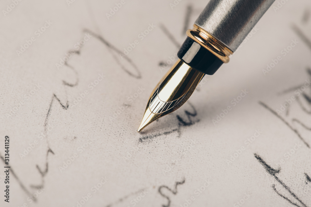 Fototapeta premium Fountain pen on an ancient handwritten letter. Old story. Retro style.