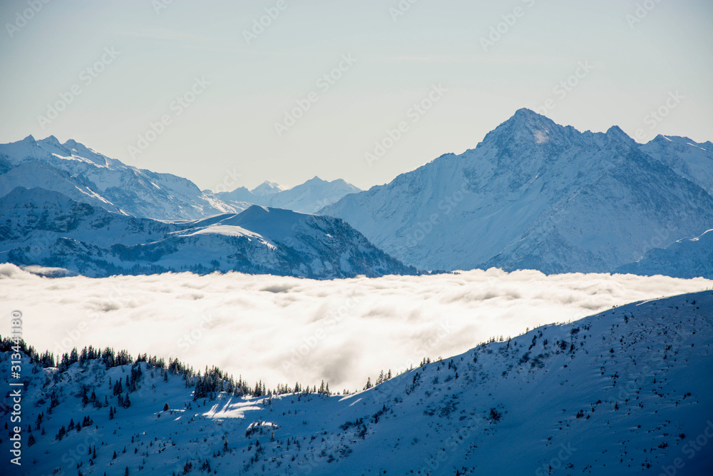 Obraz premium blue winter mountain panorama, snow covered blue mountain layers