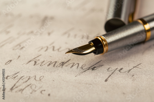 Fountain pen on an ancient handwritten letter. Old story. Retro style.