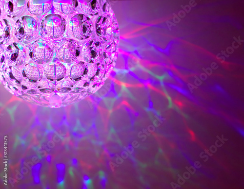 Disco ball with color feflections, lights on the background photo