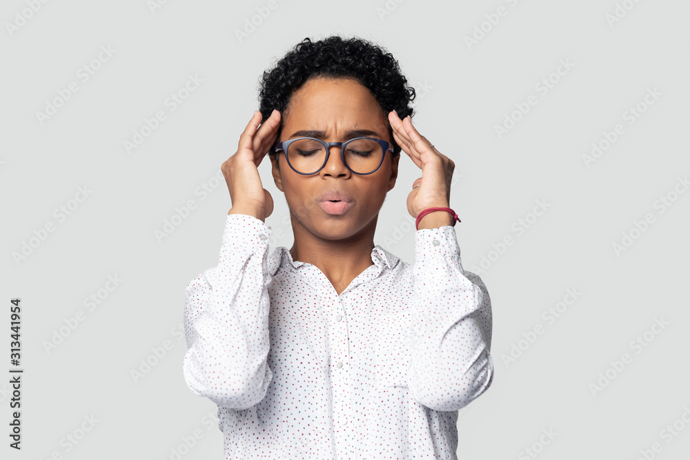 African woman closed eyes reduces stress makes breathing exercises African woman closed eyes reduces stress makes breathing exercises