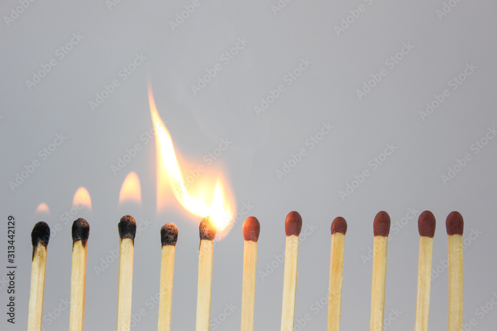 burning match on black background burning match on black background