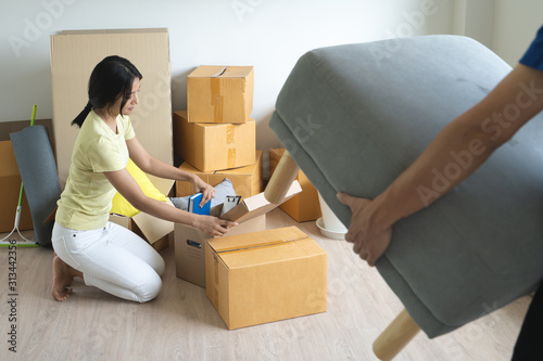 Asian couple lover unpacking thing after relocation to new apartment.
