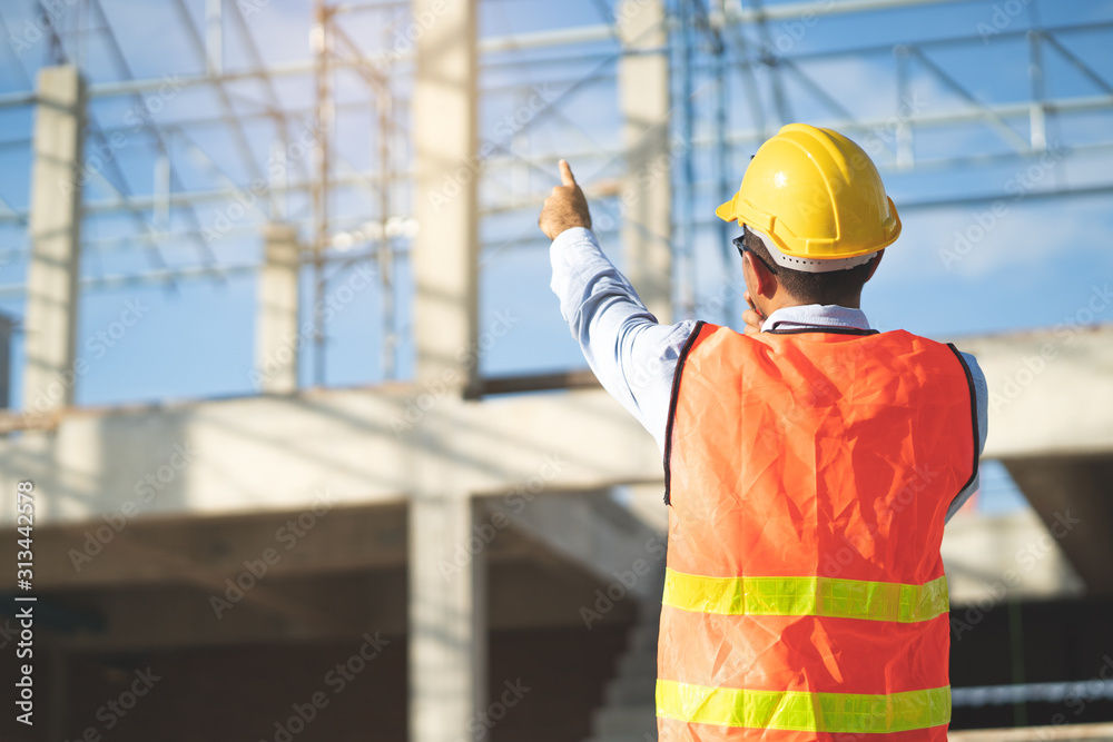 Asian inspector checking structure of new property and taking note in the clipboard for review and fix the house before sell to client