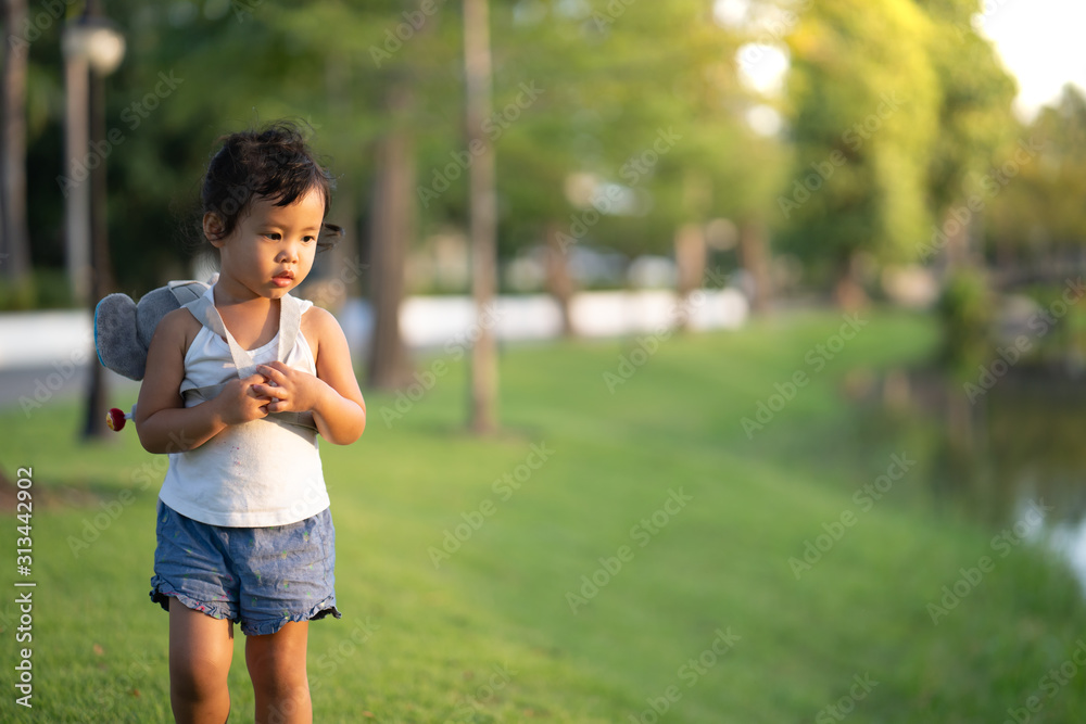 Cute little girl playing at park during sunset hour. Cute little girl playing at park during sunset hour.