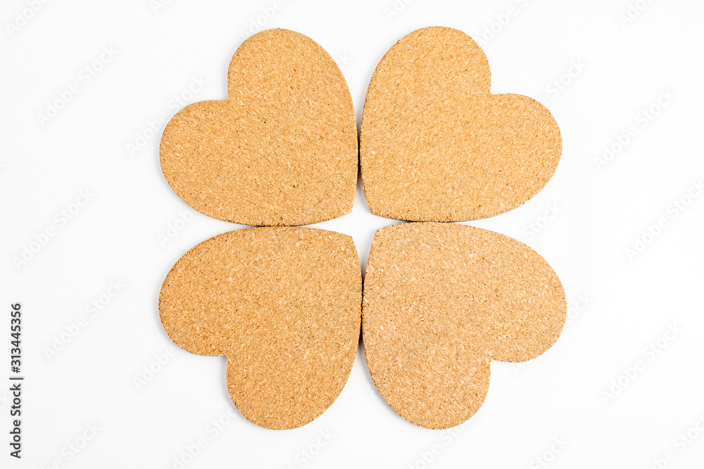 Shape with four hearts made from light brown textured cardboard, isolated on white with space for text