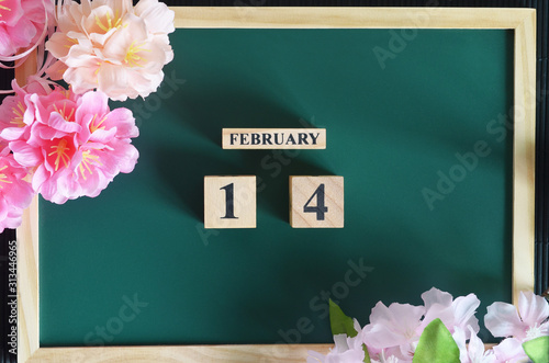 February 14, Cover Date design with sakura flower on the wood green board.
