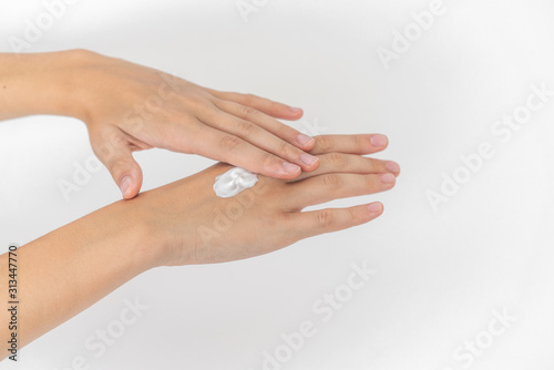 Hand skin care. Closeup on woman's hands applying moisturizing hand cream on. Cream for hands and treatment.