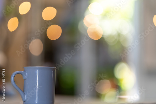 Coffee mug with smoke and blurred lights bokeh background.