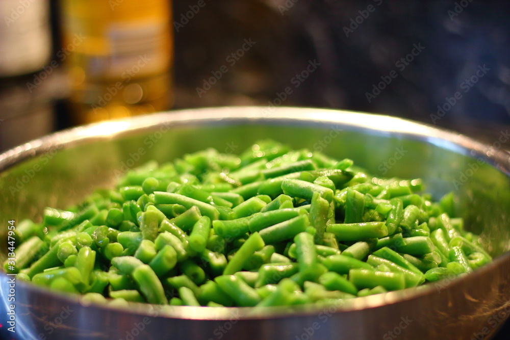 Green beans in a steel pan on a dark background. Green beans in a steel pan on a dark background.