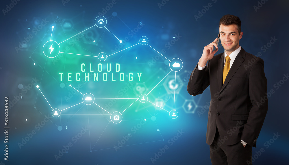 Businessman in front of cloud service icons with CLOUD TECHNOLOGY inscription, modern technology concept Businessman in front of cloud service icons with CLOUD TECHNOLOGY inscription, modern technology concept