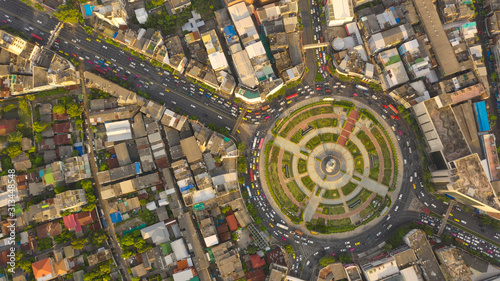 Road roundabout with car lots Wongwian Yai in Bangkok,Thailand. street large beautiful downtown at evening light. Aerial view , Top view ,cityscape ,Rush hour traffic jam.
