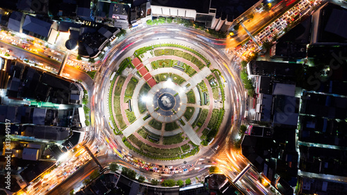 Road roundabout with car lots in Bangkok,Thailand. street large beautiful downtown at evening light. Aerial view , Top view ,cityscape ,Rush hour traffic jam.