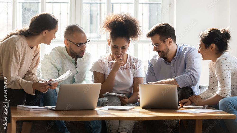 Multiracial millennial students brainstorm studying together at home Multiracial millennial students brainstorm studying together at home