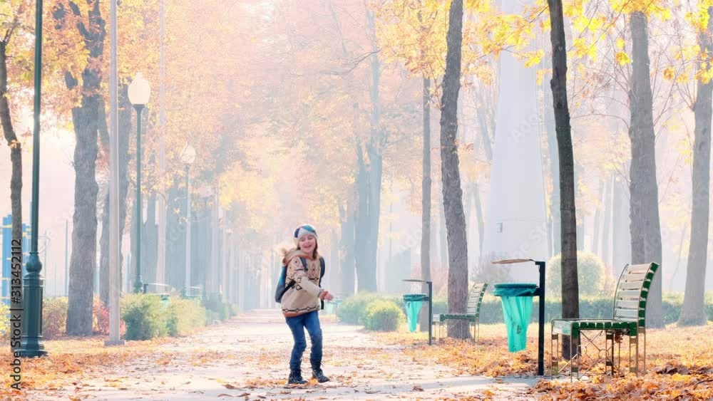 Pretty girl with backpack running in autumn park Pretty girl with backpack running in autumn park