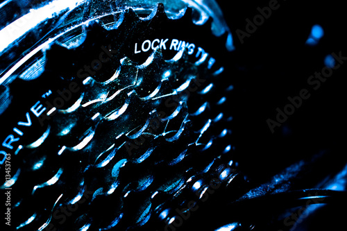 Macro photo of a metallic bicycle / bike speed cassette in bluish light photo