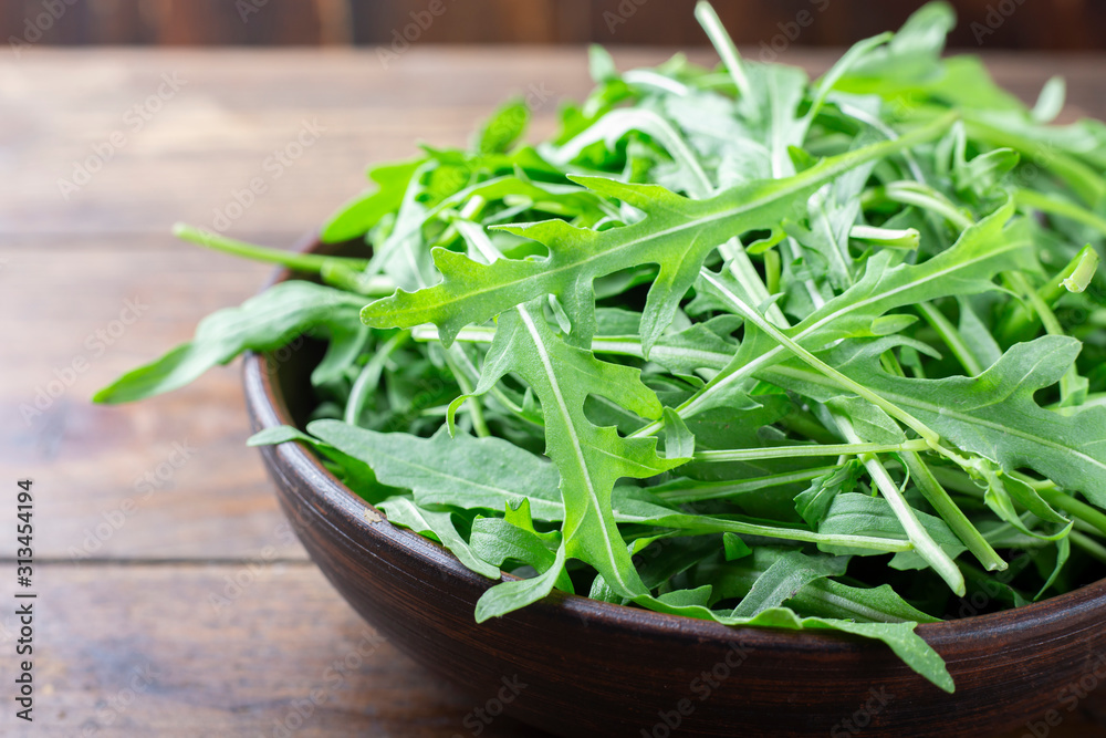 fresh arugula on a wooden background fresh arugula on a wooden background