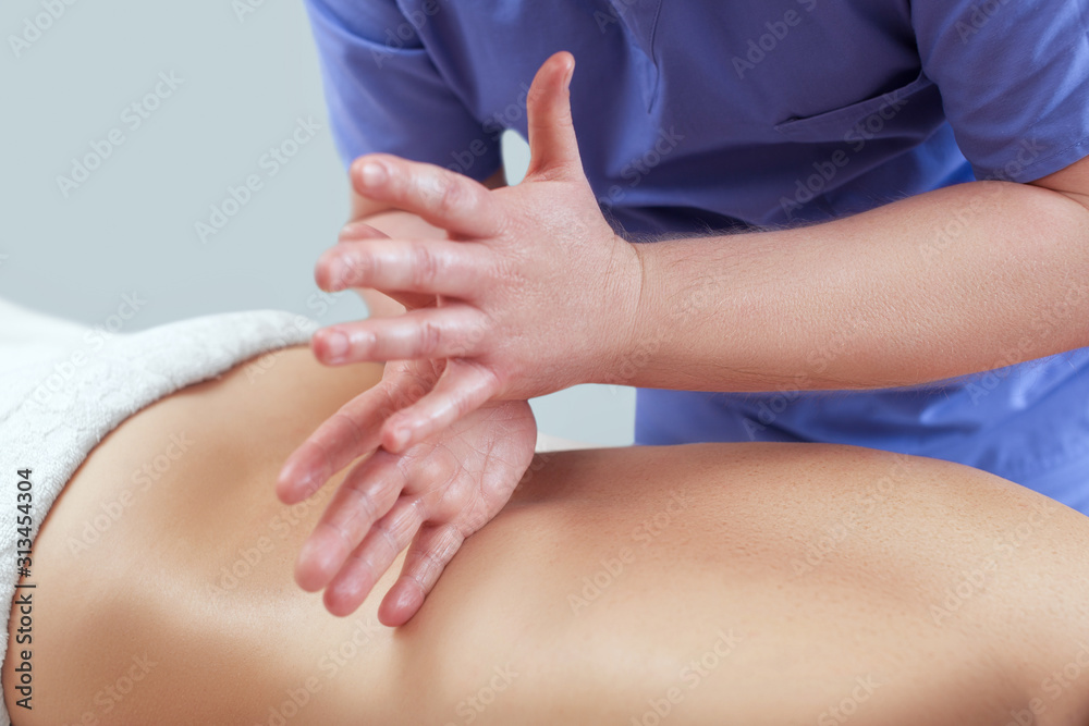 Masseur makes a relaxing massage on the neck, shoulders and back of a young beautiful woman in a spa. Cosmetology and massage concept. Masseur makes a relaxing massage on the neck, shoulders and back of a young beautiful woman in a spa. Cosmetology and massage concept.