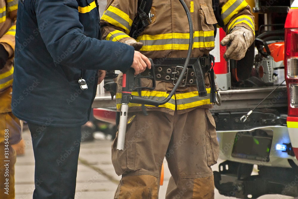 Training firefighters. Demonstration rescue work. Firefighter near the fire truck. Training firefighters. Demonstration rescue work. Firefighter near the fire truck.