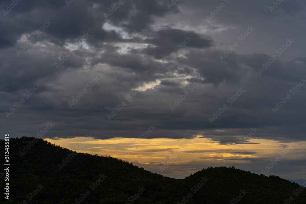 Mountain scape against sunset sky.