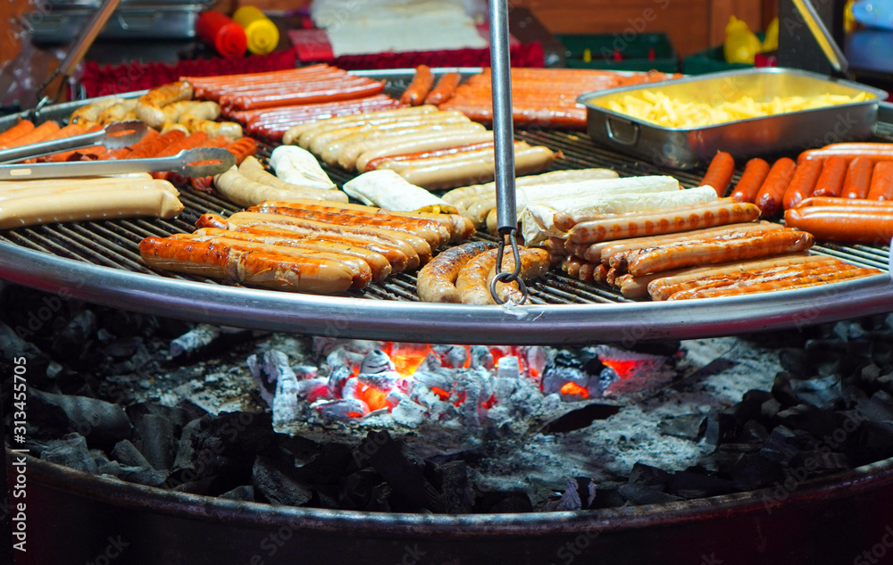 Street food background with assortment of grilled sausages
