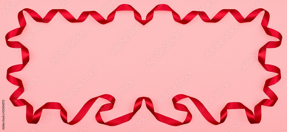Red wavy ribbon on pink background. Holiday decoration. Valentine's Day decoration congratulation frame. Red wavy ribbon on pink background. Holiday decoration. Valentine's Day decoration congratulation frame.