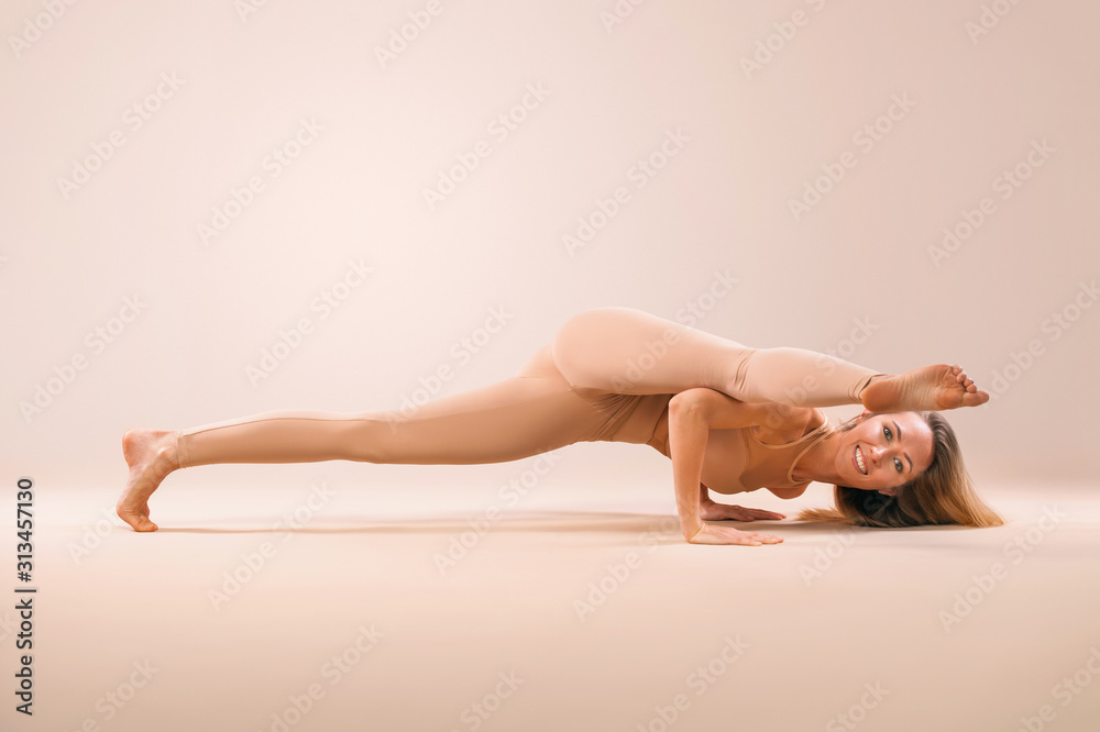 Indoor Yoga Classes. Sports recreation. Beautiful young woman in asana  pose. Individual sports. Nude sportswear. Stock Photo