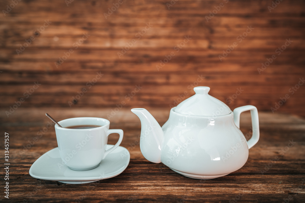 Tea time, brewing tea, cup of freshly brewed tea, warm soft and light, with wooden background Tea time, brewing tea, cup of freshly brewed tea, warm soft and light, with wooden background