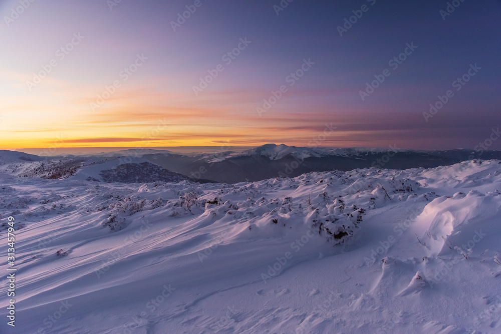 Mountain winter landscape in the Ukrainian Carpathians on the background of the sunset.