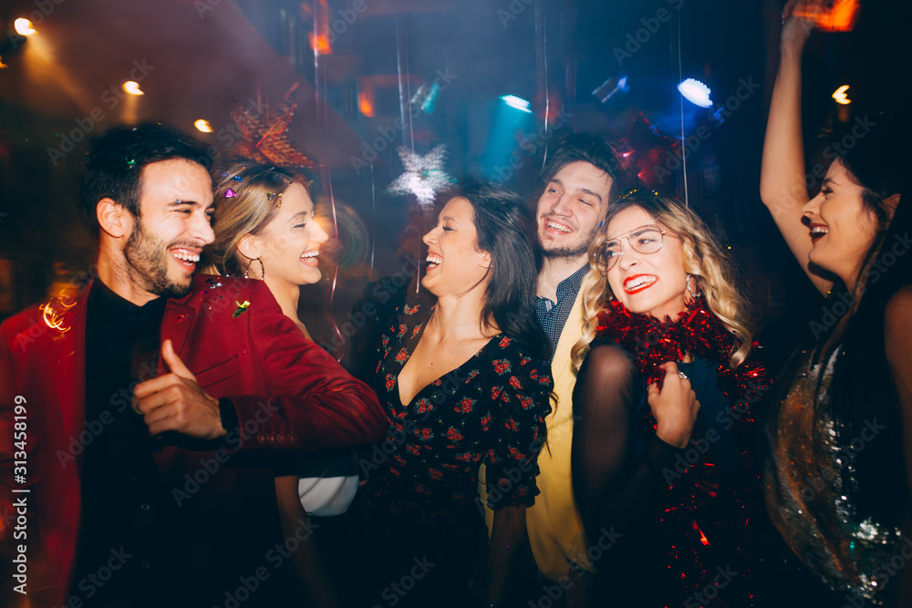 Group of friends dancing at the New Year's party