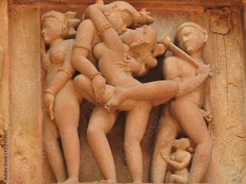 Obraz na płótnie Erotic sculptures and sex poses of man in kajuraho temples, Madhya Pradesh, India. Built around 1050, it is a UNESCO world heritage site, a tourist destination. The concept of textures and postcards. w salonie
