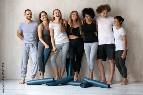 Happy diverse friends having fun after yoga training together