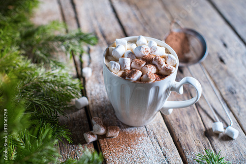 White cup of coffee with marshmallows and cocoa