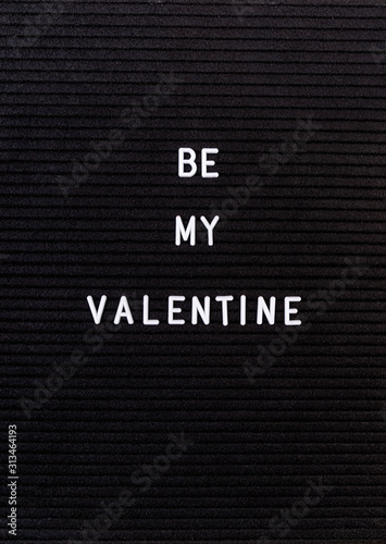 The words Be My Valentine on black felt letter board