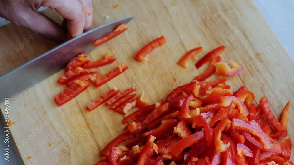 Preparation of vegetables for freezing, cutting bell pepper on a cutting board. Frozen vegetables. sliced. Preparation of vegetables for freezing, cutting bell pepper on a cutting board. Frozen vegetables. sliced.