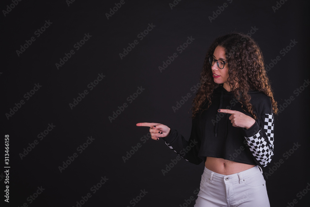 Young girl model posing with cute racing sweater in black background Young girl model posing with cute racing sweater in black background