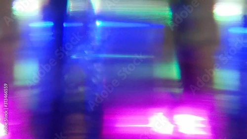 Dynamic blurred video. Flashing colored lights, neon behind the glass. Motion video. Colorful garlands. Blurred view. Bright illuminated scene. Abstract background, backdrop for any purpose