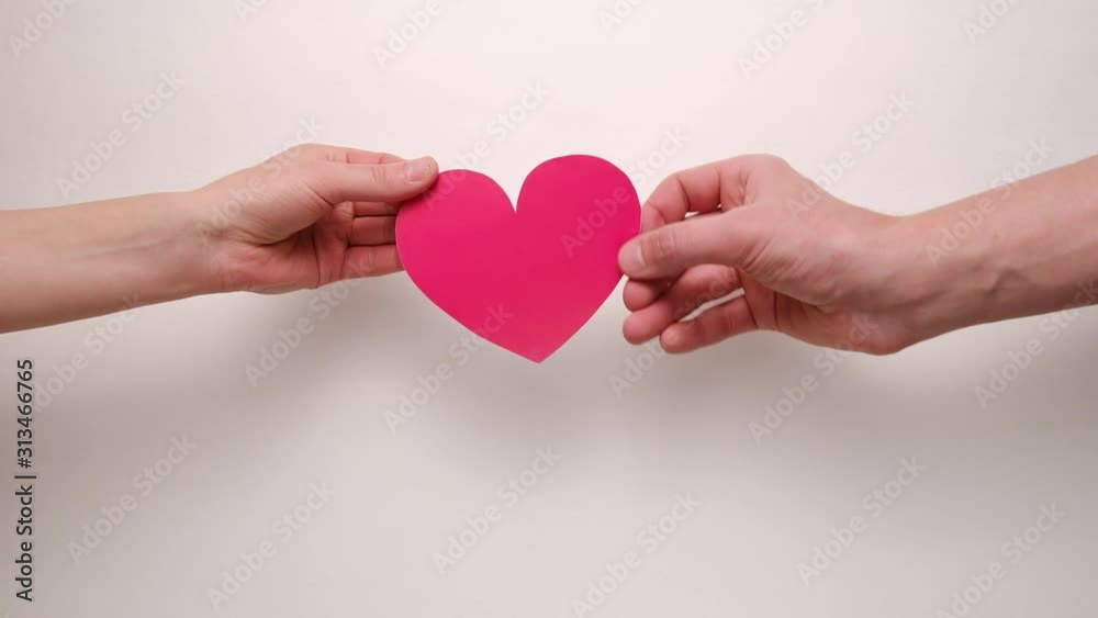 Male gives female in hands little white hearts isolated on white background. Valentine's day and like blogging blog social network tenderness concept. Male gives female in hands little white hearts isolated on white background. Valentine's day and like blogging blog social network tenderness concept.