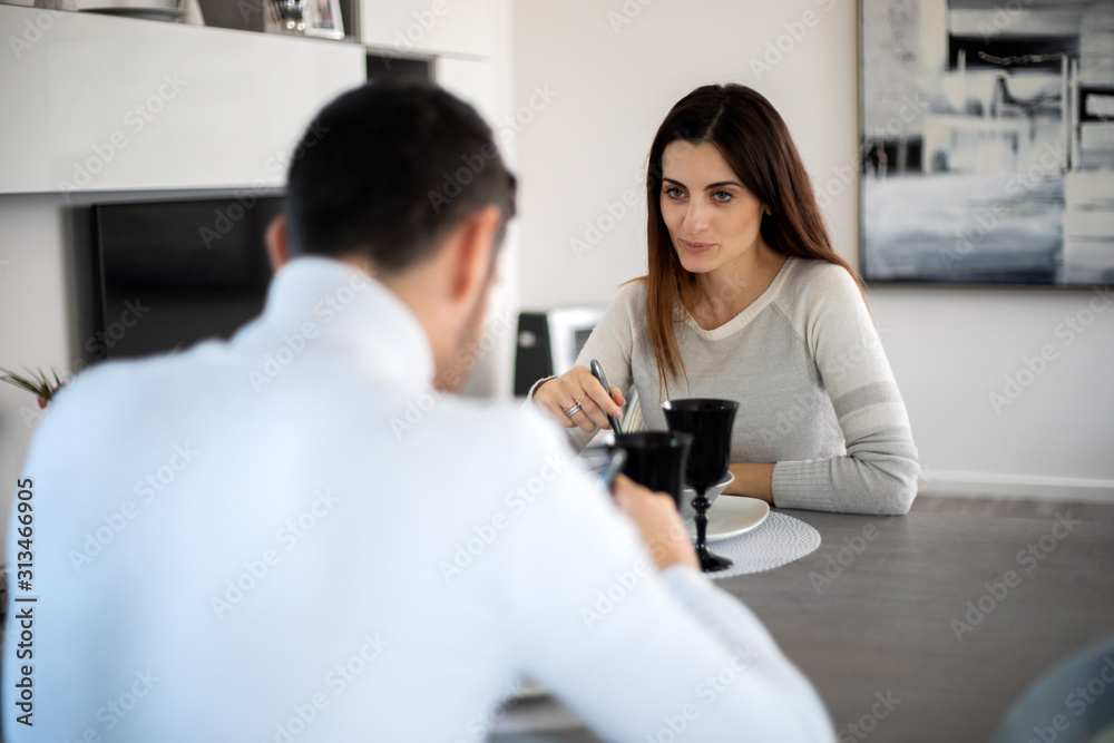 Attractive couplehaving a romantic dinner at home alone Attractive couplehaving a romantic dinner at home alone